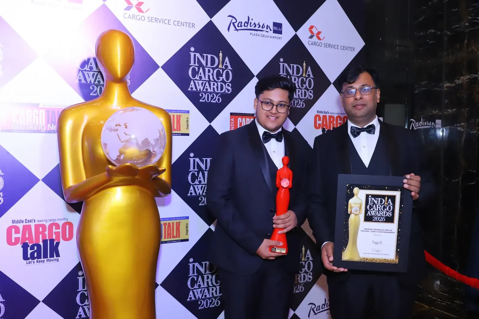 The FreighAI team holding the India Cargo Awards 2026 trophy and certificate in front of the CargoTalk backdrop
